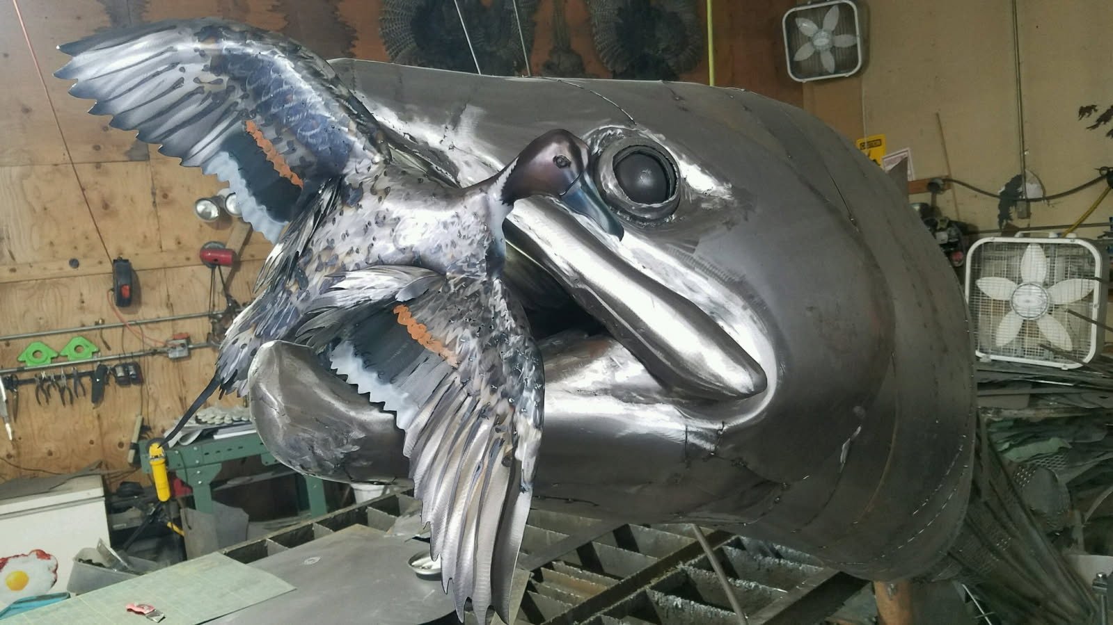 Large metal fish fabrication in workshop