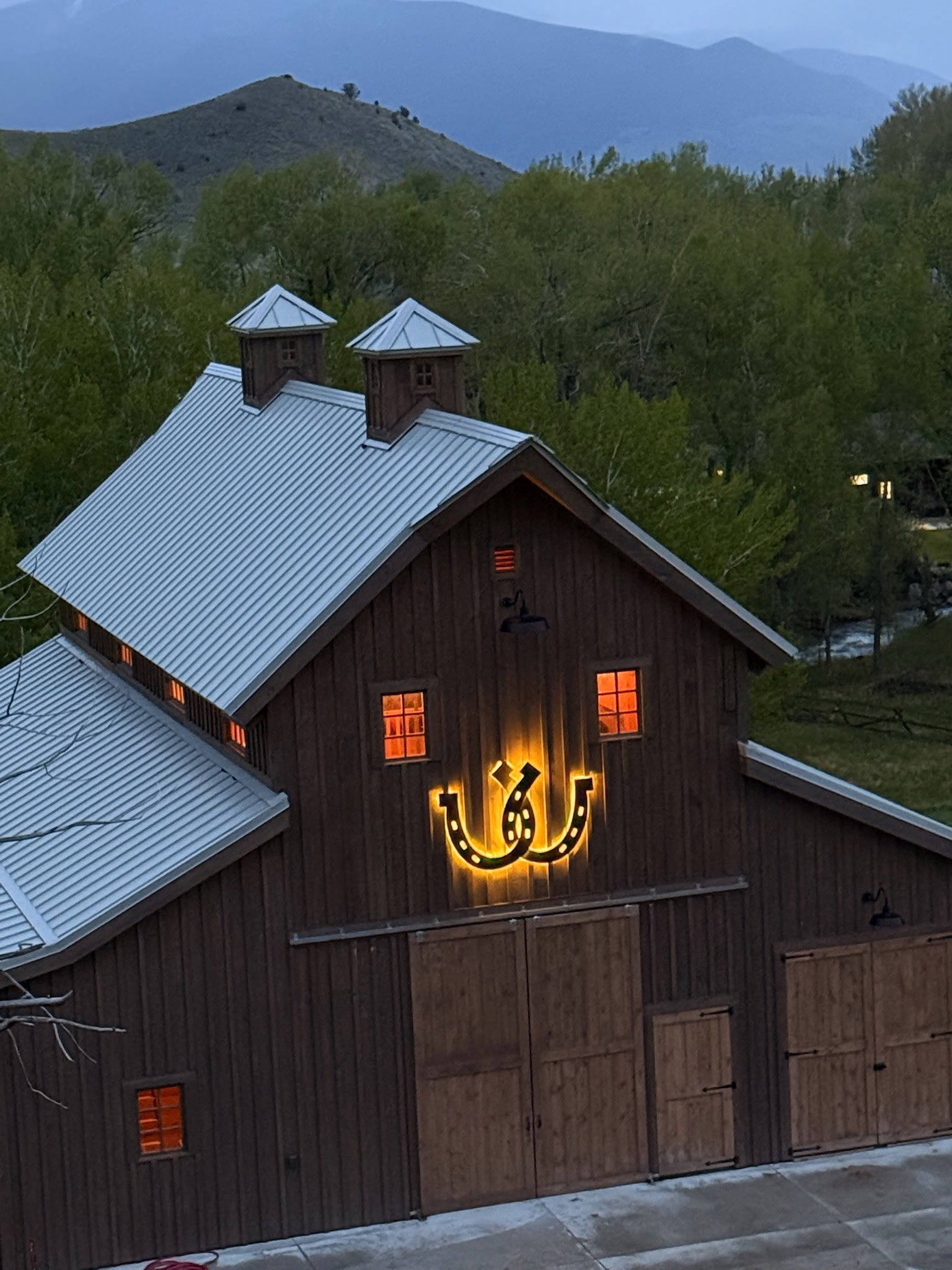 Large illuminated horseshoe barn installation