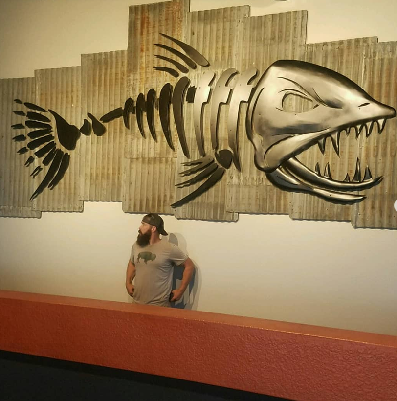 Metal fish sculpture installed at restaurant